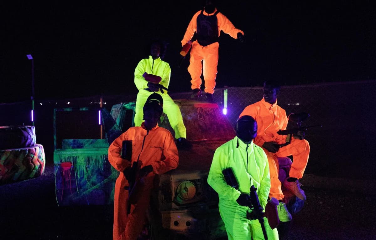 Players enjoying UV paintball in Marrakech at night with glowing outfits and immersive blacklight experience